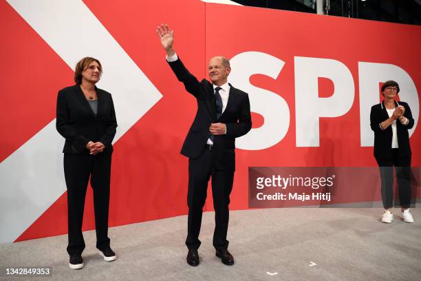 Olaf Scholz , chancellor candidate of the German Social Democrats , waves to supporters next to his wife Britta Ernst and SPD leader Saskia Esken in...