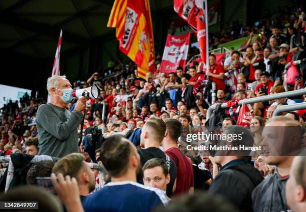 Head coach Christian Streich of Freiburg stays with a megaphon inside the stand after the Bundesliga match between Sport-Club Freiburg and FC...