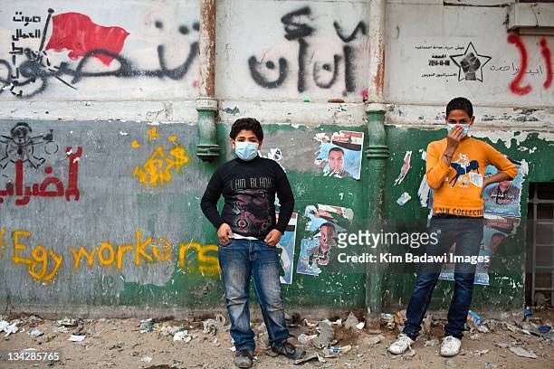 After an evening of street battles with Egyptian security forces and demonstrators children stand on Mohamed Mahmoud Street in downtown Cairo a...
