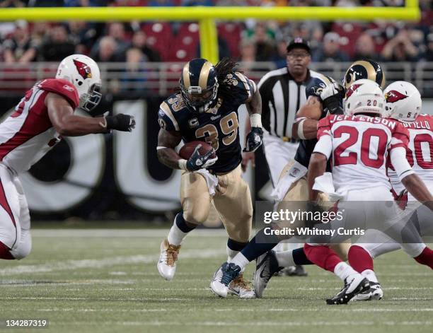 Running back Steven Jackson of the St. Louis Rams runs the ball with pressure from cornerback A.J. Jefferson of the Arizona Cardinals in the second...