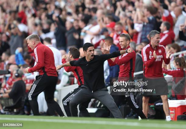 Mikel Arteta manager of Arsenal celebrates their teams second goal during the Premier League match between Arsenal and Tottenham Hotspur at Emirates...