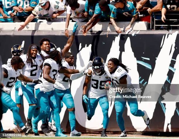 Jamal Agnew of the Jacksonville Jaguars celebrates with teammates after returning a missed FG for a touchdown during the first half in the game...