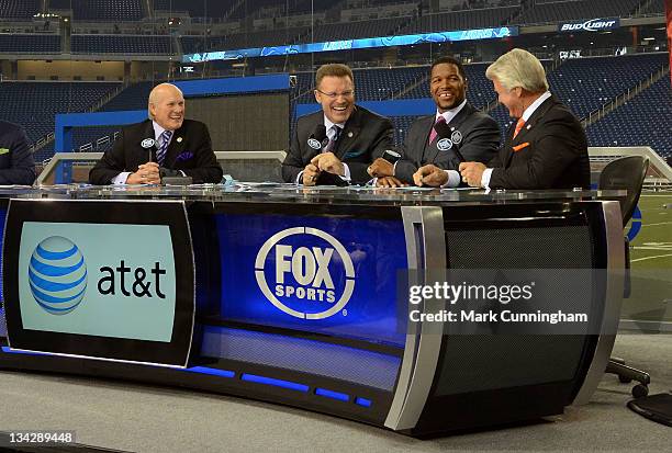Terry Bradshaw, Howie Long, Michael Strahan and Jimmy Johnson host the FOX television NFL Postgame Show from the sidelines after the game between the...
