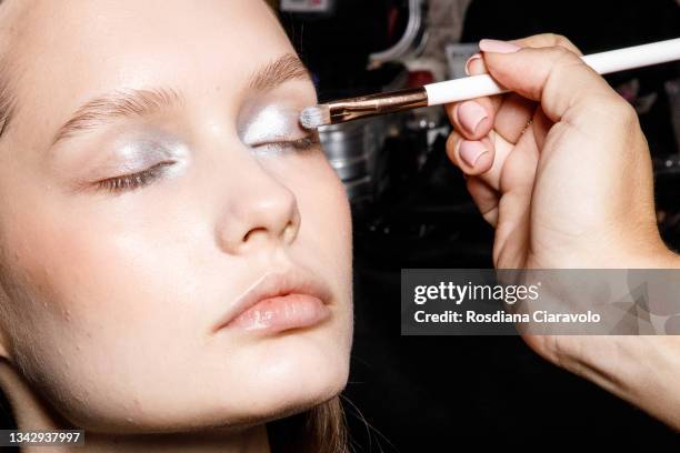 Model is seen during make up in the backstage of the Hui fashion show during the Milan Fashion Week - Spring / Summer 2022 on September 26, 2021 in...