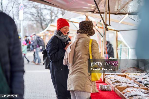 women friends doing shopping at flea market in the city - autumn friends coats stock pictures, royalty-free photos & images