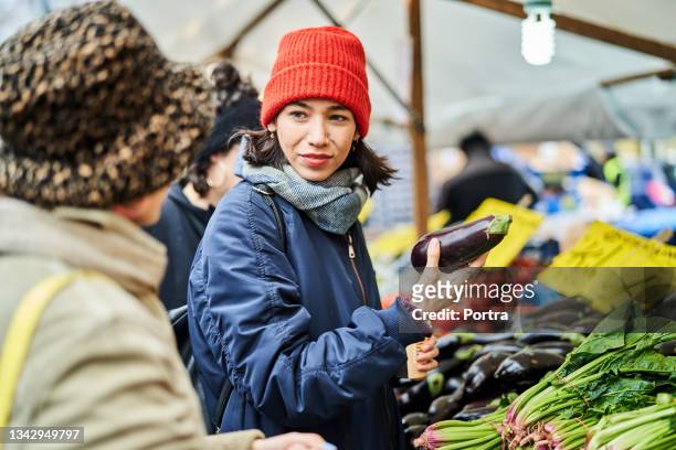 female friends buying vegetables at local market in the city - winter berlin bildbanksfoton och bilder