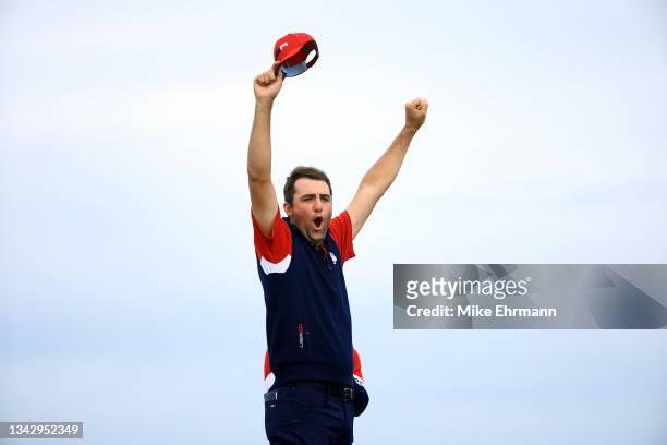 Scottie Scheffler of team United States celebrates on the 15th green after defeating Jon Rahm of Spain and team Europe 4&3 during Sunday Singles...