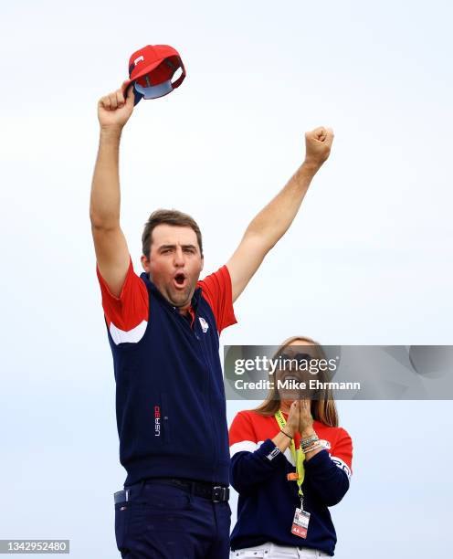 Scottie Scheffler of team United States and wife Meredith Scudder celebrate on the 15th green after defeating Jon Rahm of Spain and team Europe 4&3...