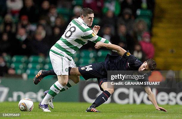 Celtic's Gary Hooper vies with Atletico Madrid's Gabi during an UEFA Europa League group I football match at Celtic Park in Glasgow on November 30,...