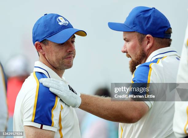 Shane Lowry of Ireland and team Europe hugs Rory McIlroy of Northern Ireland and team Europe on the 16th green after losing to Patrick Cantlay of...