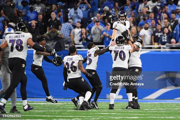 Justin Tucker of the Baltimore Ravens celebrates the winning field goal with his team in the game against the Detroit Lions at Ford Field on...