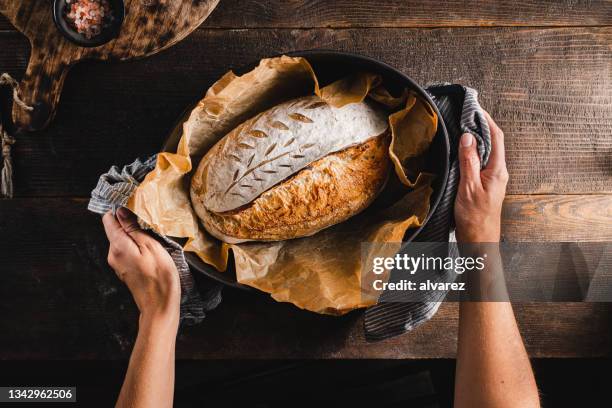 woman baking sourdough bread in kitchen - baking bread stock pictures, royalty-free photos & images