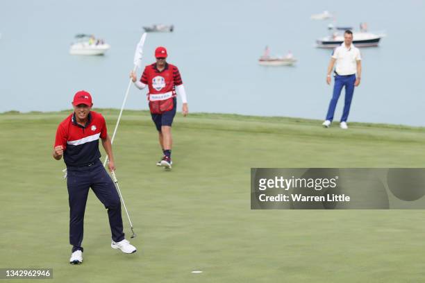 Collin Morikawa of team United States celebrates on the 17th green after going 1up to guarantee the half point needed for the United States to win...