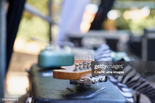 side view guitar musical instrument on table top amplifier backstage - backstage music stock pictures, royalty-free photos & images