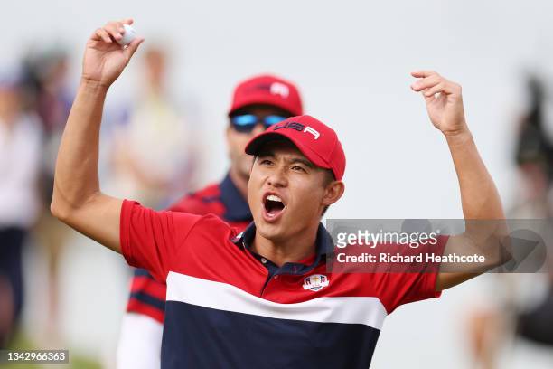 Collin Morikawa of team United States celebrates on the 17th green after winning the hole to go 1up and guarantee the half point needed for the...