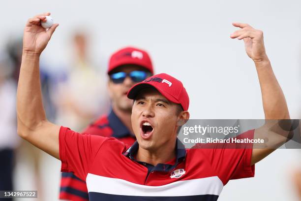 Collin Morikawa of team United States celebrates on the 17th green after winning the hole to go 1up and guarantee the half point needed for the...