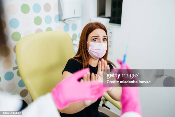 young woman getting vaccinated - rädda bildbanksfoton och bilder