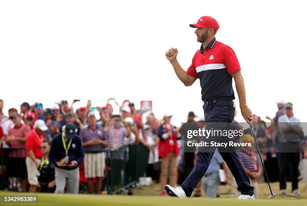 Dustin Johnson of team United States celebrates on the 15th green during his match against Paul Casey of England and team Europe during Sunday...