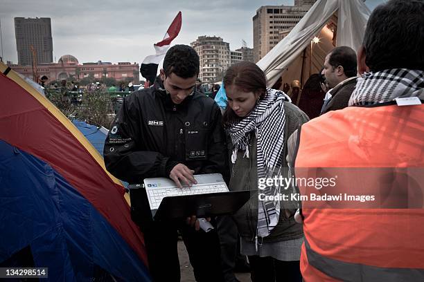 Activist check twitter updates on eve of elections in downtown Cairo on November 27, 2011 in Cairo, Egypt.