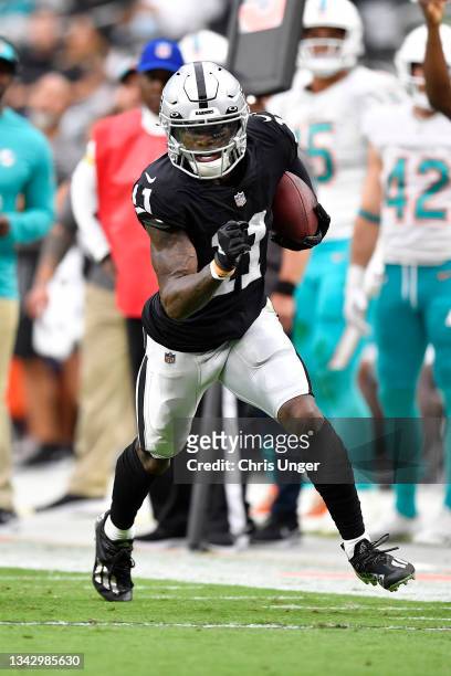 Henry Ruggs III of the Las Vegas Raiders runs with the ball after the catch in the second quarter of the game against the Miami Dolphins at Allegiant...