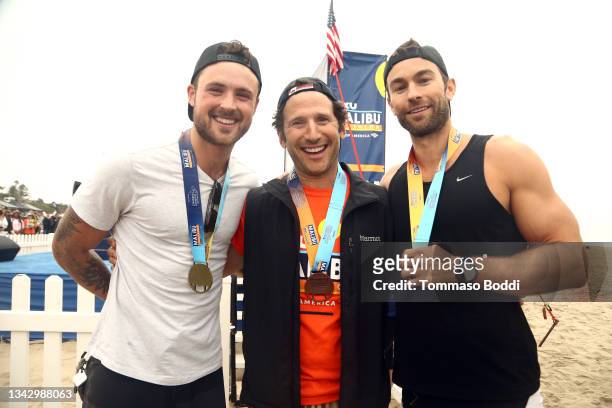 Dylan Efron, Mark Feuerstein and Chace Crawford compete in the celebrity race at the 34th Annual Malibu Triathlon at Zuma Beach on September 26, 2021...