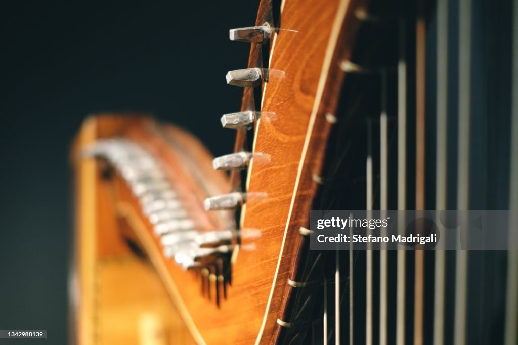 Harp wooden instrument with strings and illuminated handle