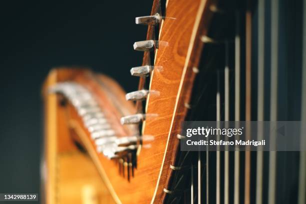 harp wooden instrument with strings and illuminated handle - arpa fotografías e imágenes de stock