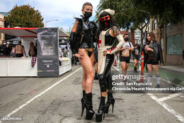 From left, Katrina Black and Alexandra Sadista, both dominatrixes from Chicago, pose for a portrait during the annual Folsom Street Fair in San...