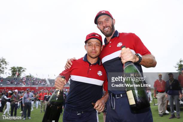 Dustin Johnson of team United States celebrates with Xander Schauffele after defeating Team Europe 19 to 9 during Sunday Singles Matches of the 43rd...