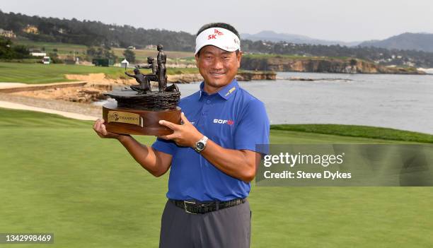 Choi of the Republic of Korea holds the trophy after on the 18th green at the Pebble Beach Golf Links after winning the PURE Insurance Championship...