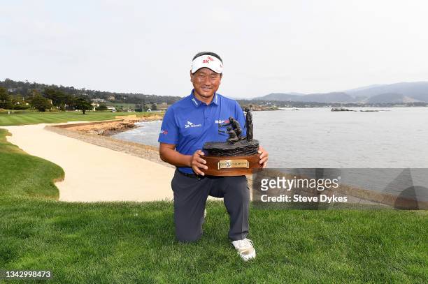 Choi of the Republic of Korea holds the trophy after on the 18th green at the Pebble Beach Golf Links after winning the PURE Insurance Championship...