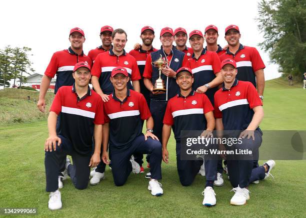 Team United States celebrates with the Ryder Cup after defeat Team Europe 19 to 9 during Sunday Singles Matches of the 43rd Ryder Cup at Whistling...