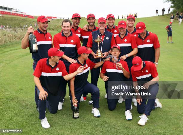 Team United States celebrates with the Ryder Cup after defeat Team Europe 19 to 9 during Sunday Singles Matches of the 43rd Ryder Cup at Whistling...