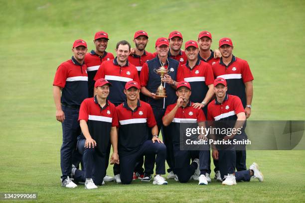 Team United States celebrates with the Ryder Cup after defeat Team Europe 19 to 9 during Sunday Singles Matches of the 43rd Ryder Cup at Whistling...