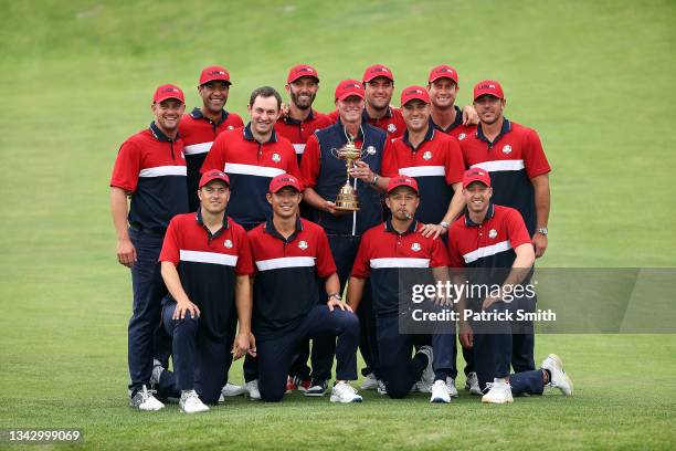 Team United States celebrates with the Ryder Cup after defeat Team Europe 19 to 9 during Sunday Singles Matches of the 43rd Ryder Cup at Whistling...