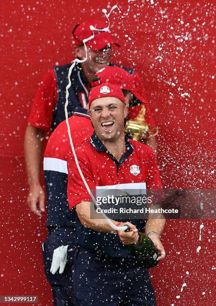 Justin Thomas of team United States celebrates with champagne after defeating team Europe during Sunday Singles Matches of the 43rd Ryder Cup at...