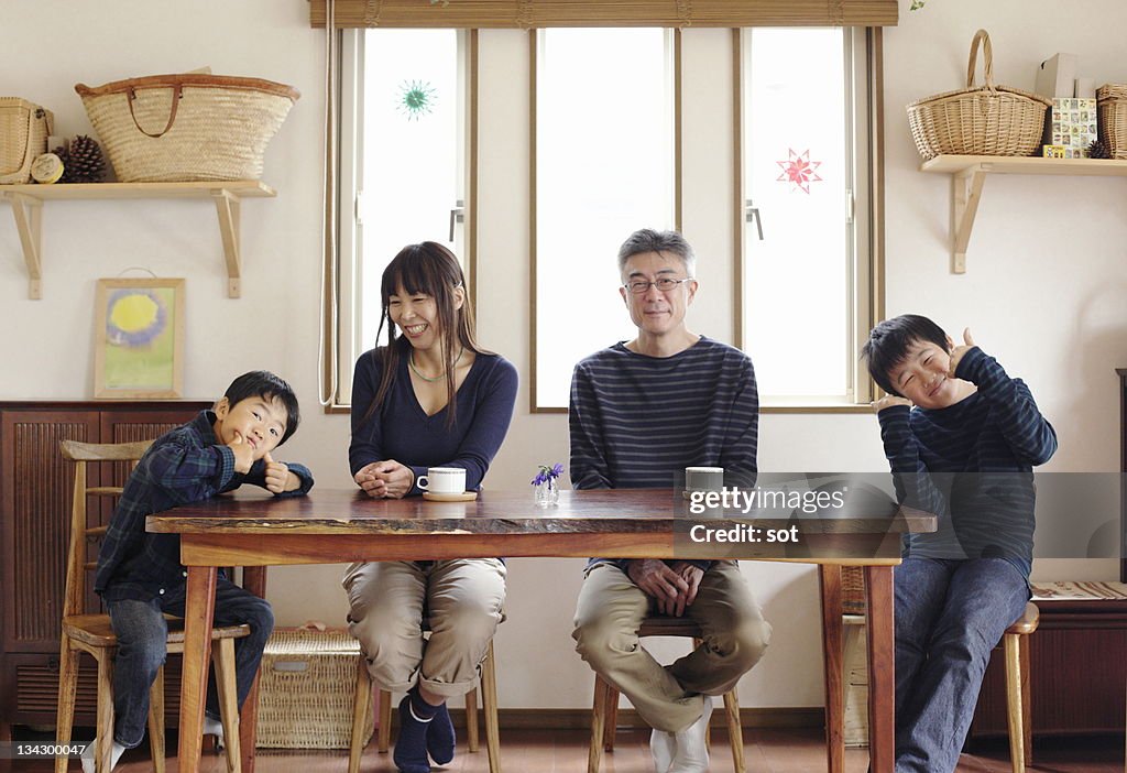Portrait of family sitting at dining table