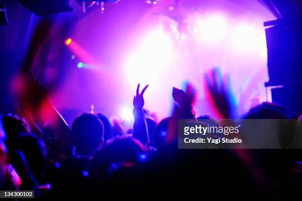 crowd with arms in air at nightclub music. - concert imagens e fotografias de stock