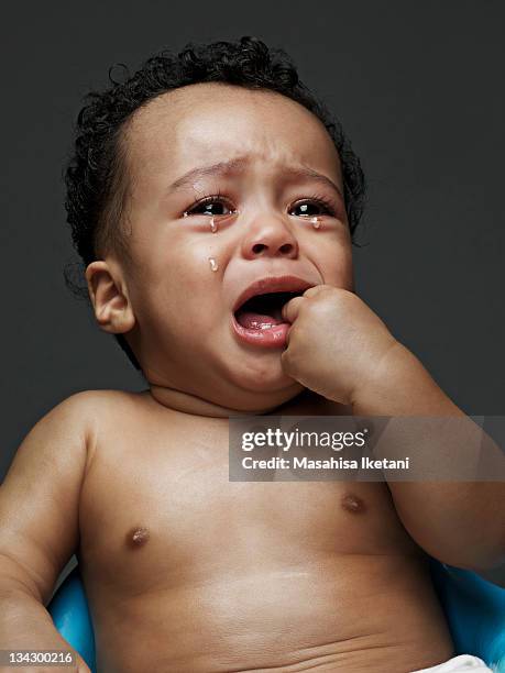 crying black and the asian person of mixed baby - teardrop stockfoto's en -beelden