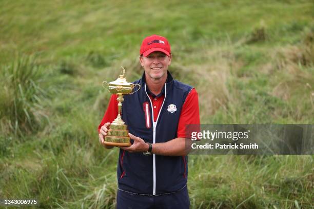 Captain Steve Stricker of team United States celebrates with the Ryder Cup after Team United States defeated Team Europe 19 to 9 in the 43rd Ryder...