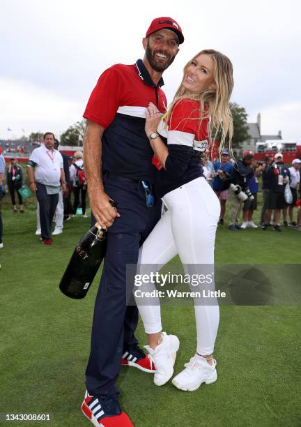 Dustin Johnson of team United States celebrates with partner Paulina Gretzky after defeating Team Europe 19 to 9 during Sunday Singles Matches of the...