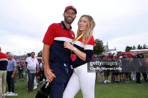 Dustin Johnson of team United States celebrates with partner Paulina Gretzky after defeating Team Europe 19 to 9 during Sunday Singles Matches of the...