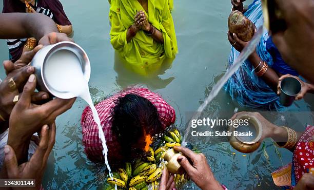 devotees pouring water and milk on woman - pilgrim stock pictures, royalty-free photos & images