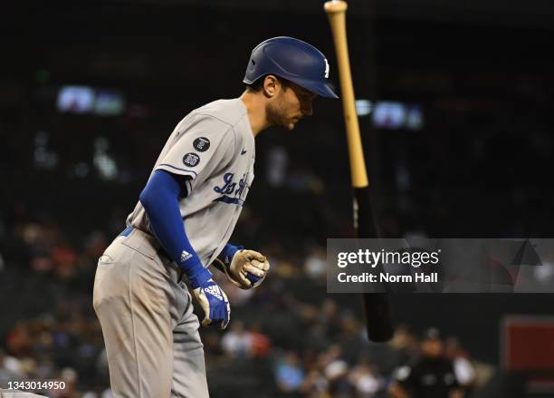 Trea Turner of the Los Angeles Dodgers throws his bat after getting walked against the Arizona Diamondbacks during the ninth inning at Chase Field on...