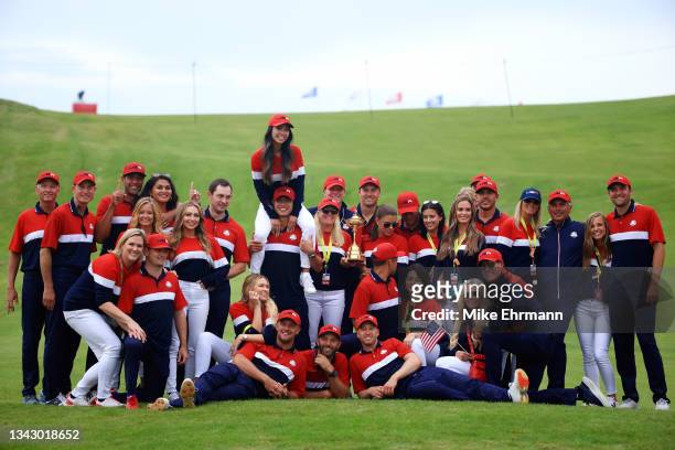 Members of team United States and their significant others celebrate after defeating Team Europe 19 to 9 to win the 43rd Ryder Cup at Whistling...