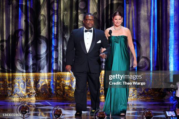 Wendell Pierce and Debra Messing speak onstage during the 74th Annual Tony Awards at Winter Garden Theatre on September 26, 2021 in New York City.