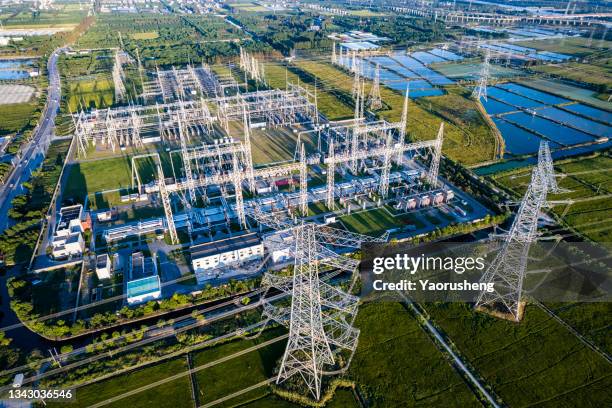 aerial view of electricity pylons and a big  electrical substation at shanghai city,china - transformer ストックフォトと画像