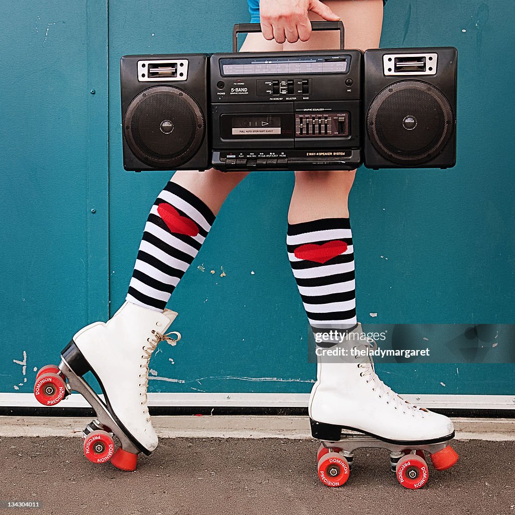 Legs of woman wearing white roller skates