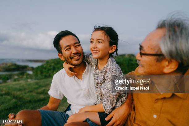 three generation family having a good time at dusk - asian family camping stock pictures, royalty-free photos & images