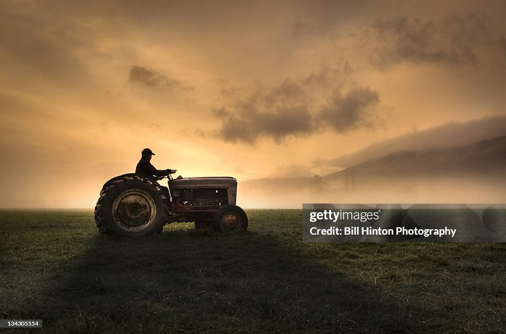 Farmer riding tractor